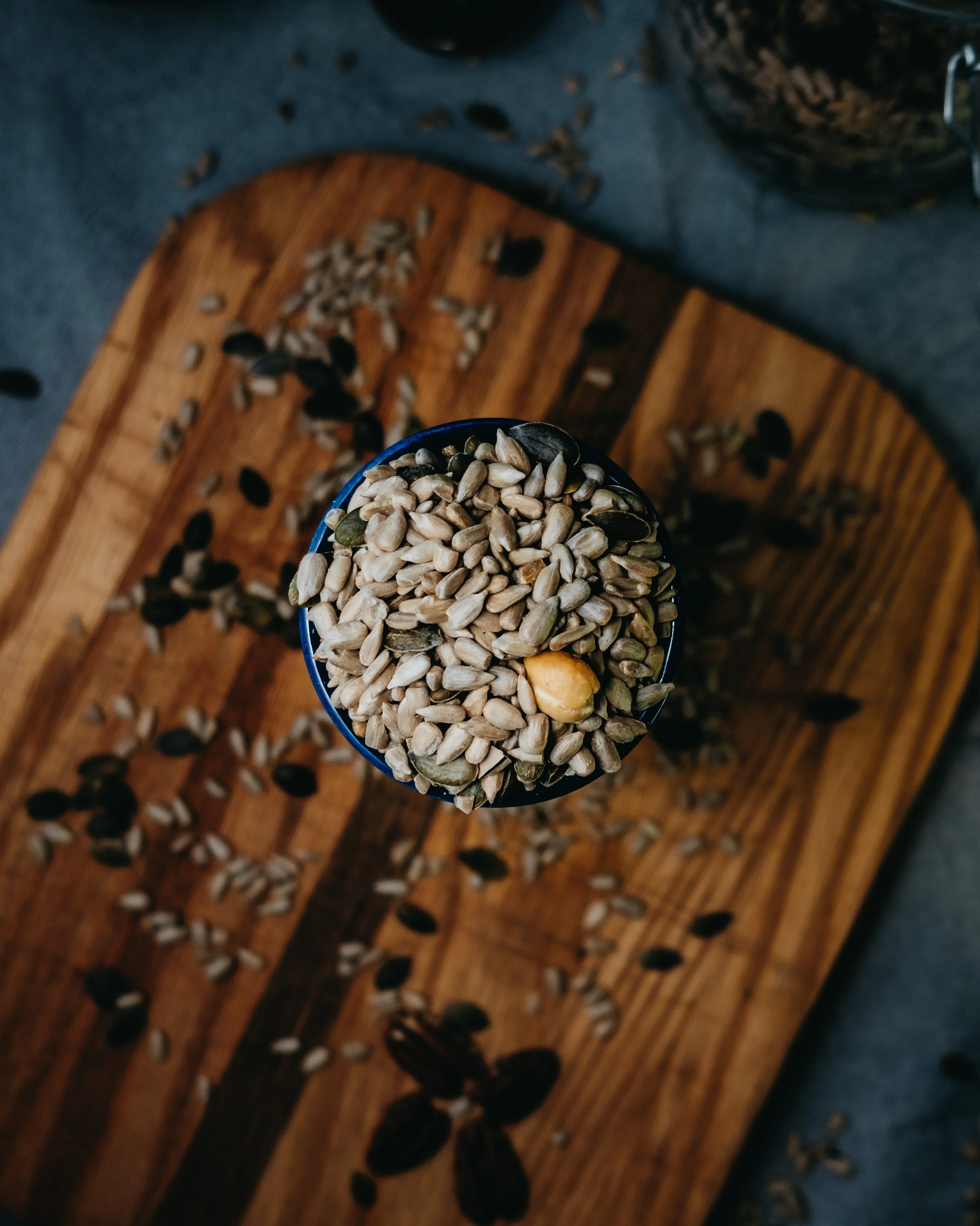 Bowl of seeds on a wooden board
